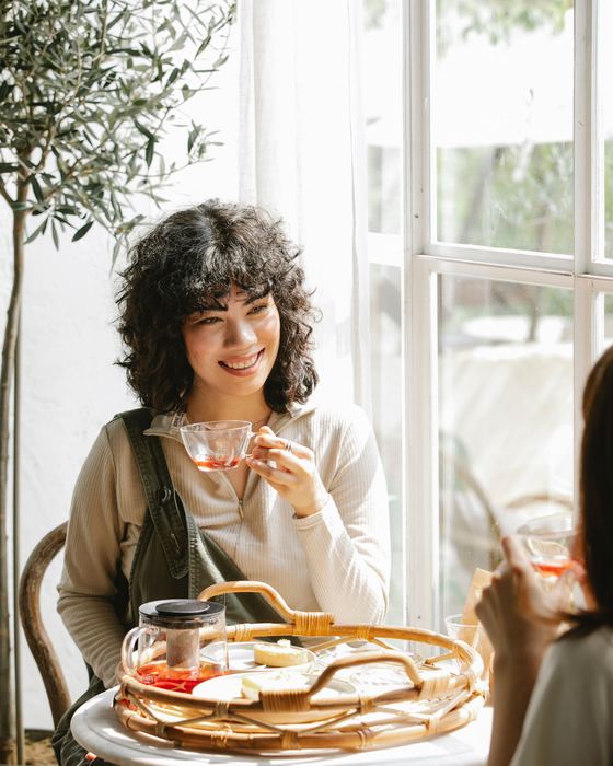 Woman enjoying a coffee in a bright café